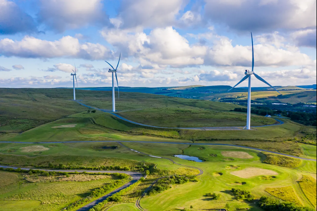 Three wind turbines in rolling hills in Wales